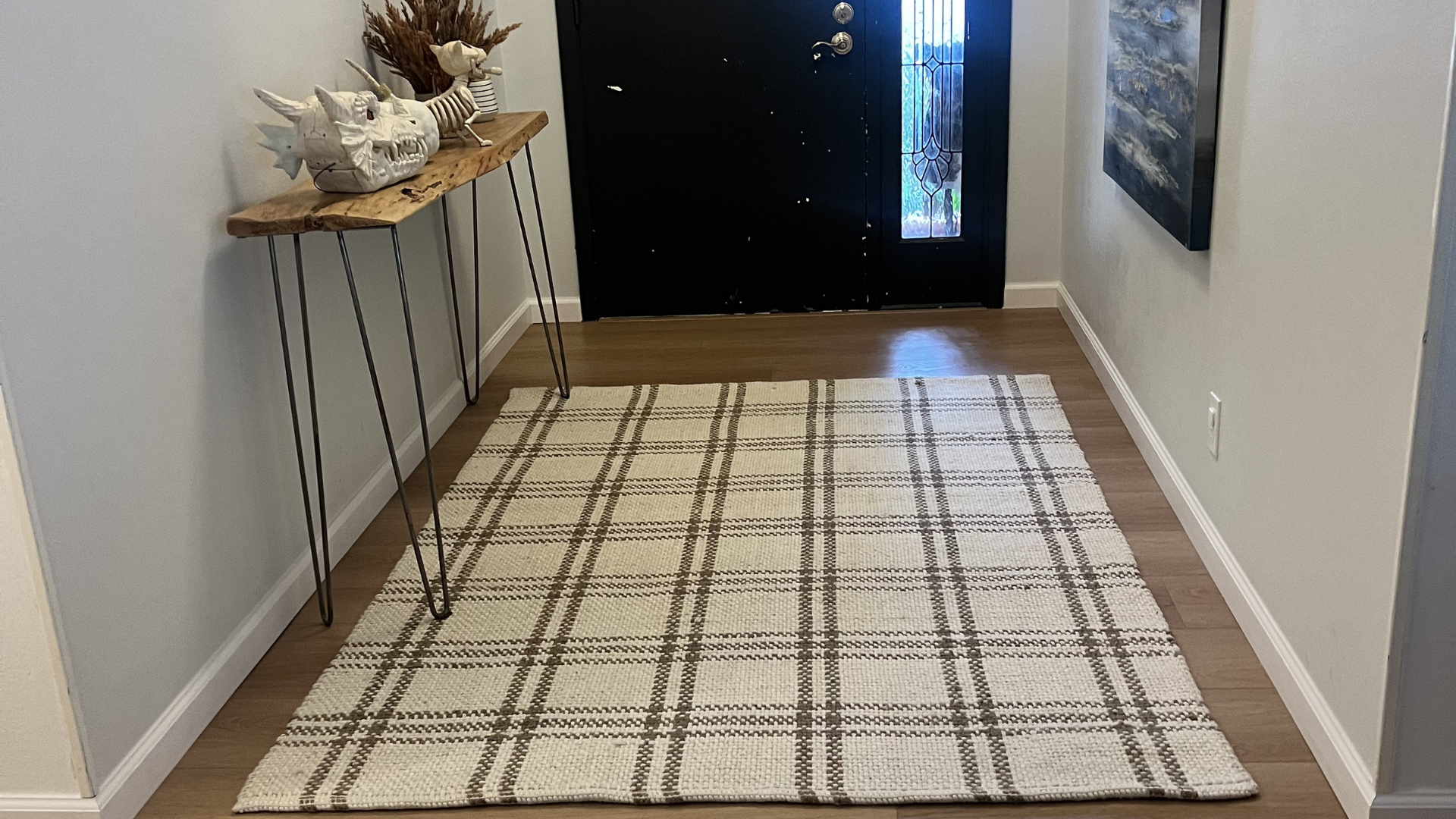 wood flooring entryway with area rug in San Antonio home